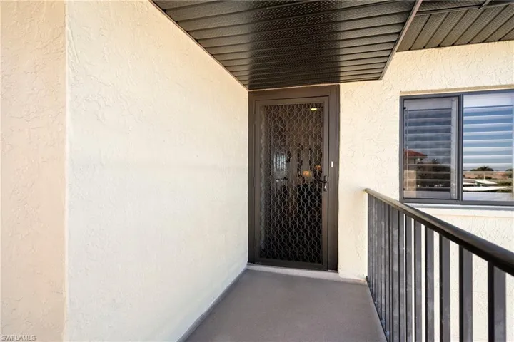 View of exterior entry featuring stucco finish