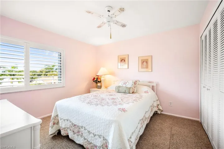 Bedroom with a ceiling fan, a closet, and carpet flooring