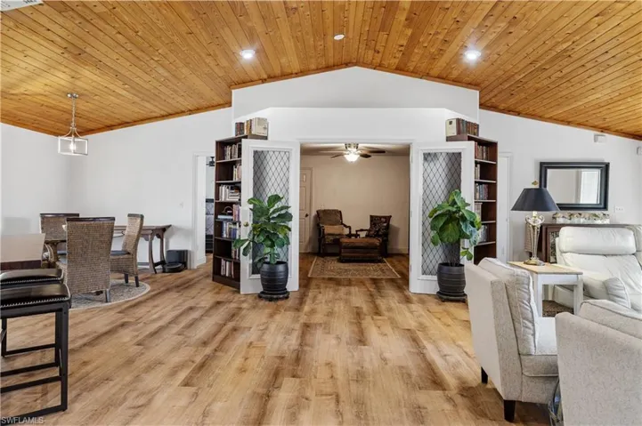 Living room with wooden ceiling, ornamental molding, light wood-style floors, a ceiling fan, and recessed lighting