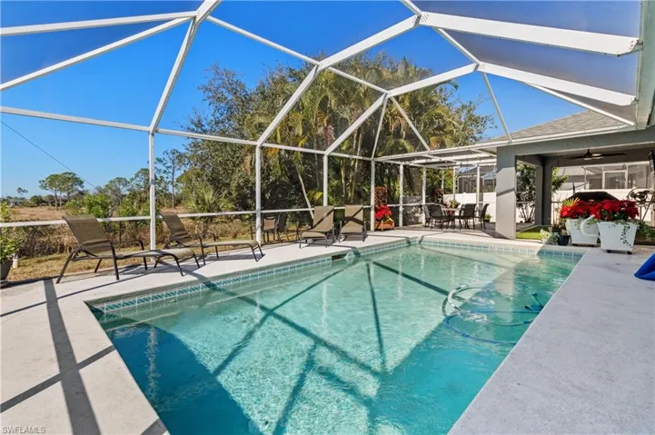Swimming pool featuring a lanai, a patio, and a sunroom