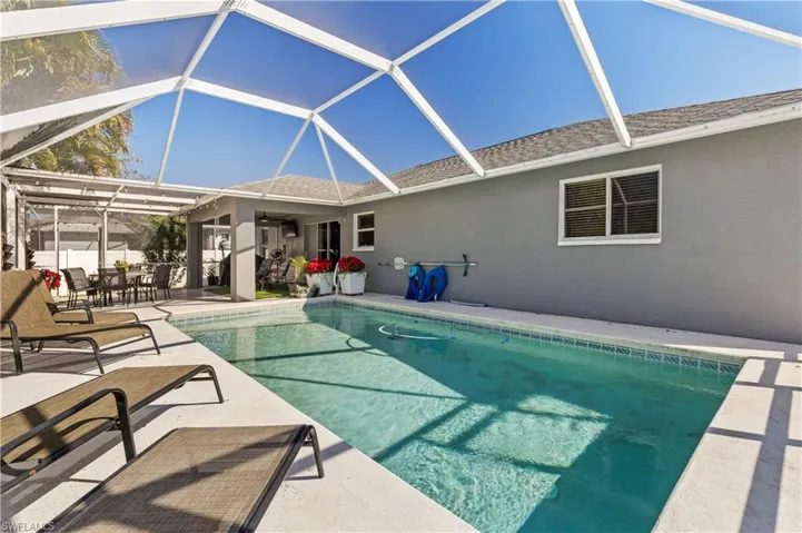 Outdoor pool featuring a lanai, a patio, a sunroom, and outdoor dining area
