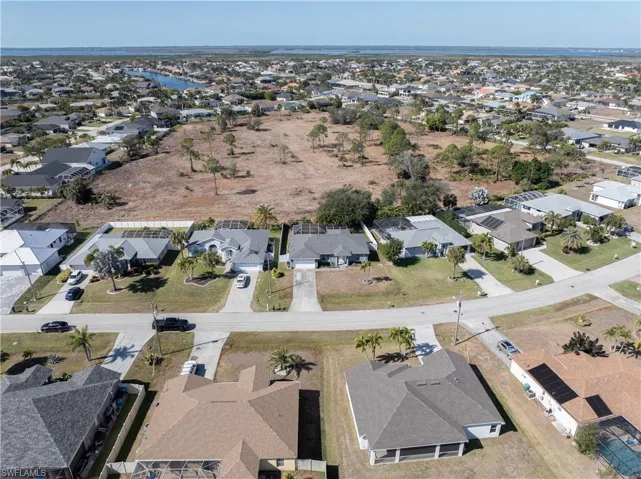 Aerial view of property's location with nearby suburban area
