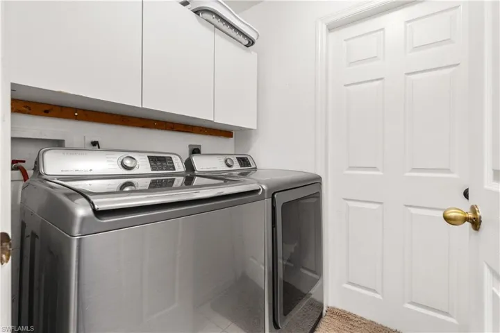 Laundry area with washer and dryer and cabinet space