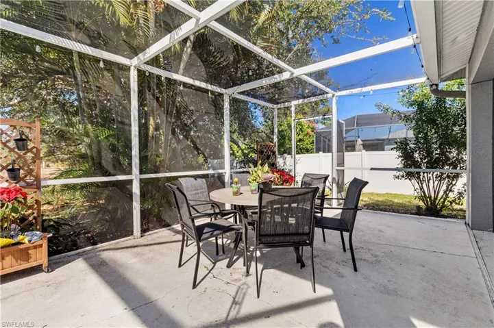 Sunroom with outdoor dining space and a patio