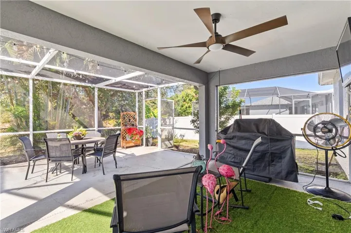 Sunroom featuring a patio area, outdoor dining space, and a ceiling fan