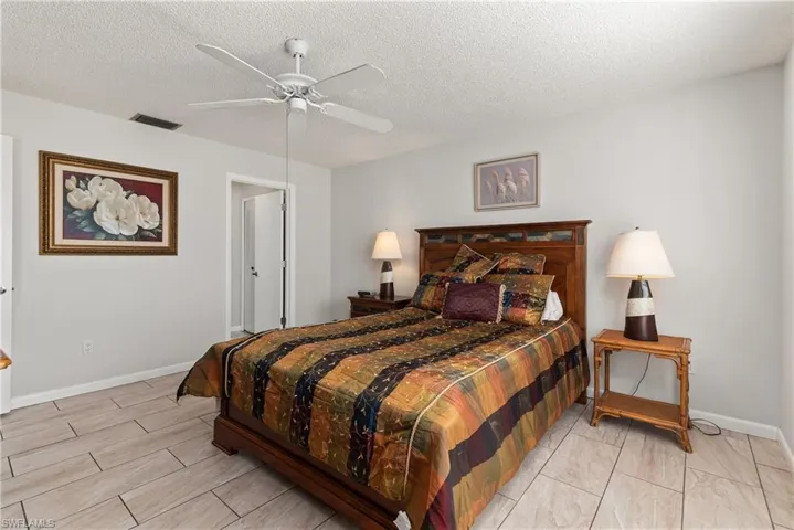 Bedroom featuring ceiling fan and a textured ceiling