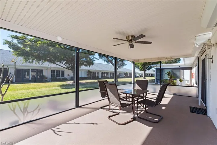 Sunroom / solarium featuring ceiling fan and outdoor dining area