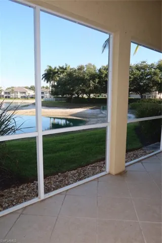 Screened patio with tile flooring and a water feature