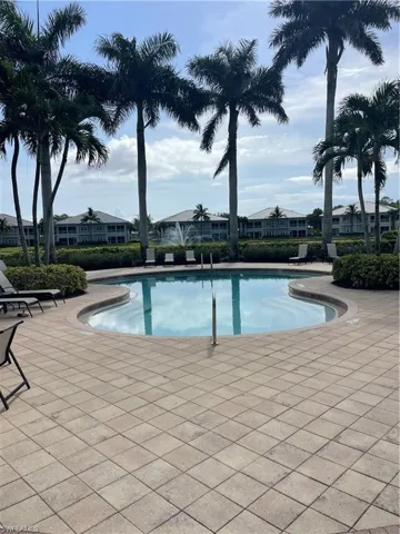 Community pool with a patio