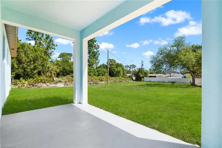 View of green lawn featuring a patio