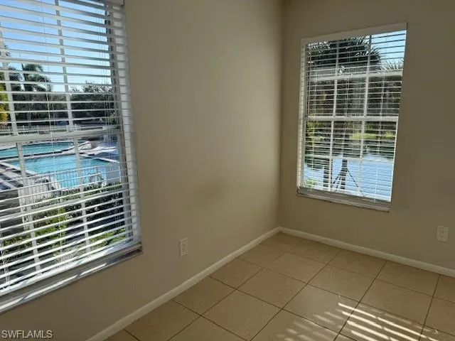 Unfurnished room with healthy amount of natural light and light tile patterned flooring
