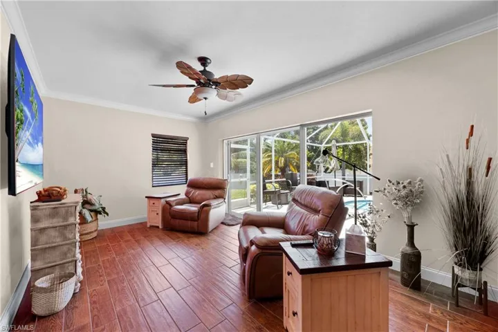 Extra den or living space with slider doors that lead out to the pool and lanai area with lots of windows and natural light