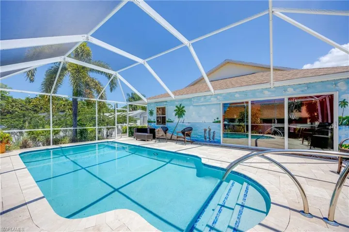 View of swimming pool with a lanai and a patio