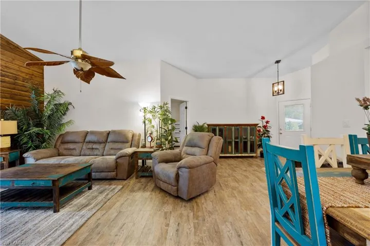 Living room with wood-style tile floors and ceiling fan