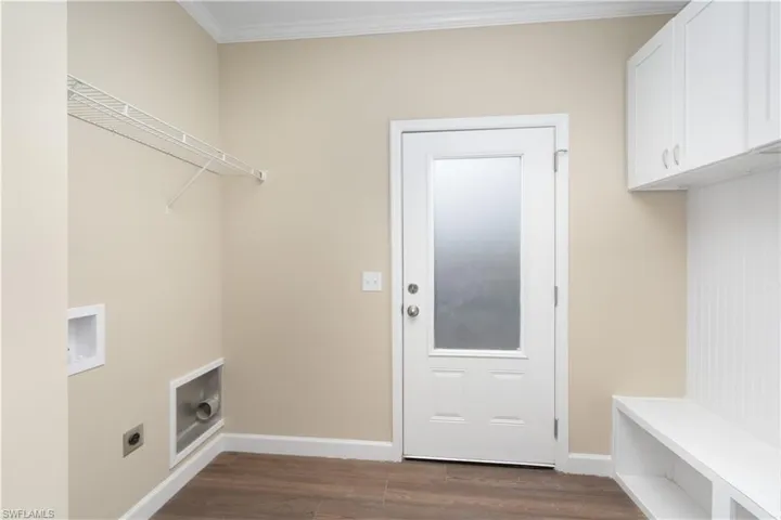 Laundry area featuring washer hookup, dark wood finished floors, crown molding, and hookup for an electric dryer