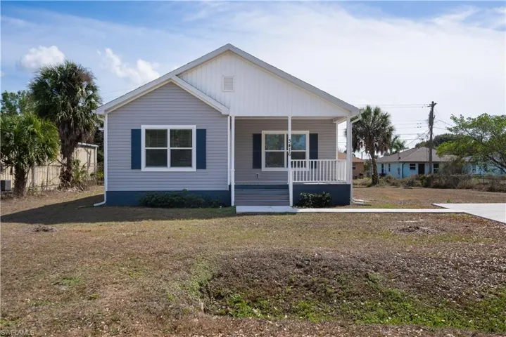 View of front of home featuring a porch and a front yard