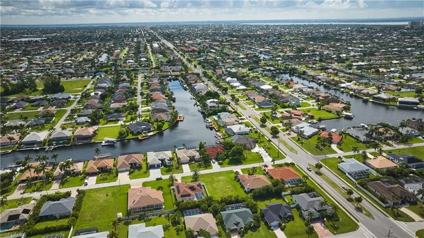 View of property location with a large body of water and nearby suburban area