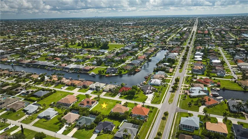 Aerial view of property's location with nearby suburban area and a nearby body of water