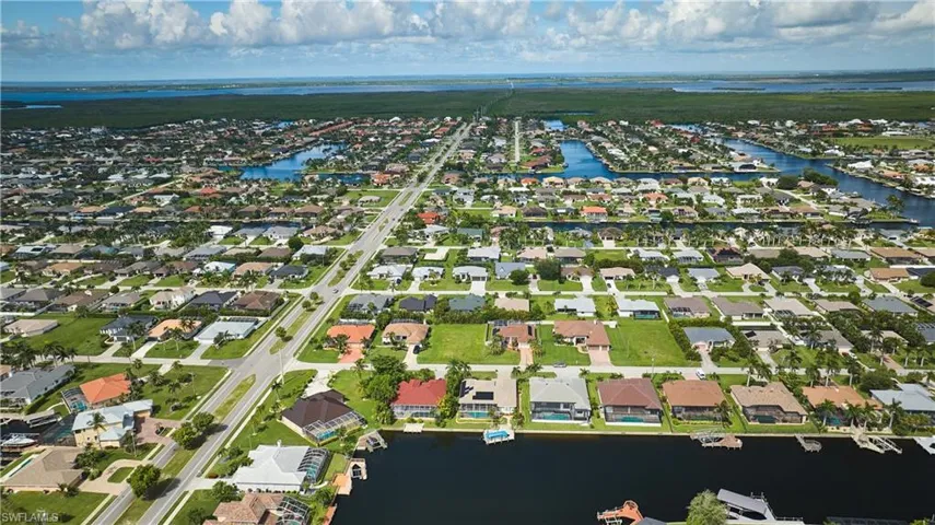 Aerial overview of property's location with a nearby body of water and nearby suburban area