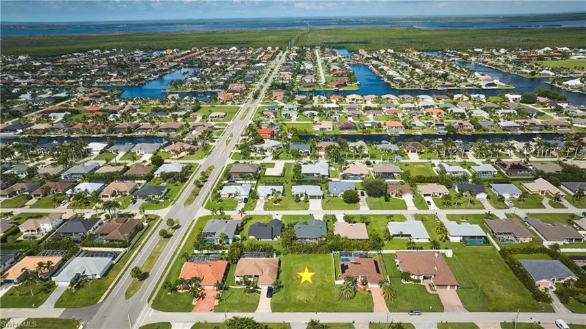 Aerial perspective of suburban area featuring a large body of water