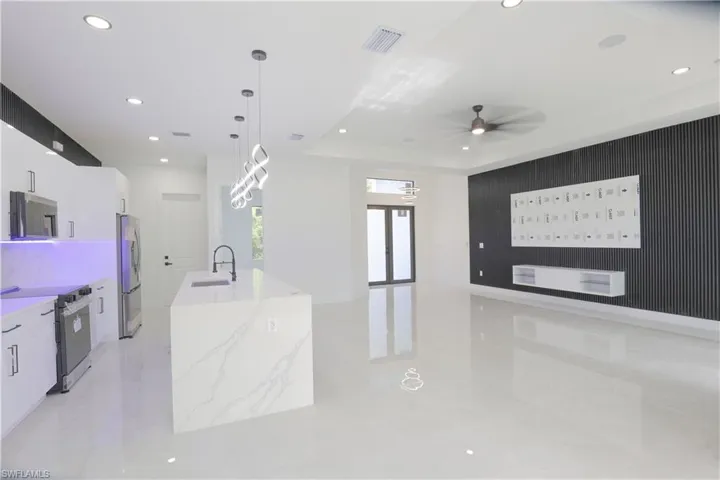 Kitchen featuring stainless steel appliances, modern cabinets, white cabinetry, recessed lighting, and a ceiling fan