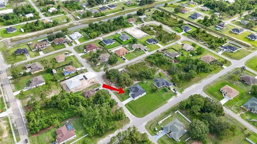 Aerial view of property and surrounding area with nearby suburban area
