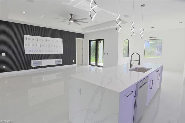 Kitchen featuring dishwasher, open floor plan, modern cabinets, ceiling fan, and recessed lighting