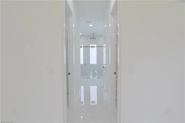 Hall with light tile patterned flooring