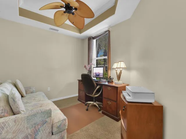 Den with tray ceiling and ceiling fan