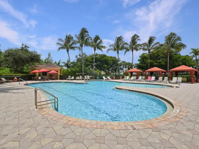 Community pool with a patio area and a gazebo