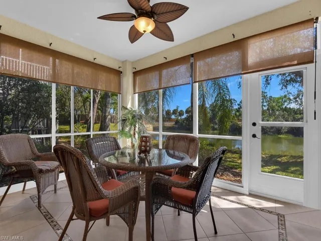 Sunroom / solarium featuring inlaid floor details, tile flooring, and a water view