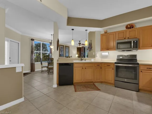 Kitchen featuring stainless steel appliances, corian countertops w/ a penensula bar
