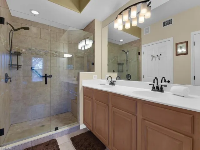 Upgraded bathroom featuring new walk in shower, double vanity, water closet and linen closet