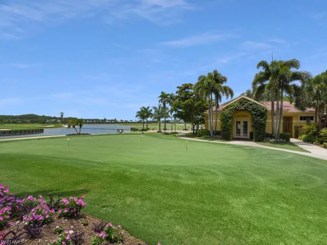 View of home's community with a putting area, view of golf course, and a water view