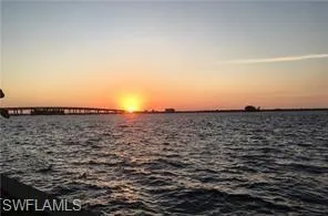 Expansive water vista featuring a distant bridge structure and a prominent horizon