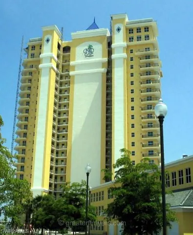 Multi-story high-rise building with a yellow and white facade