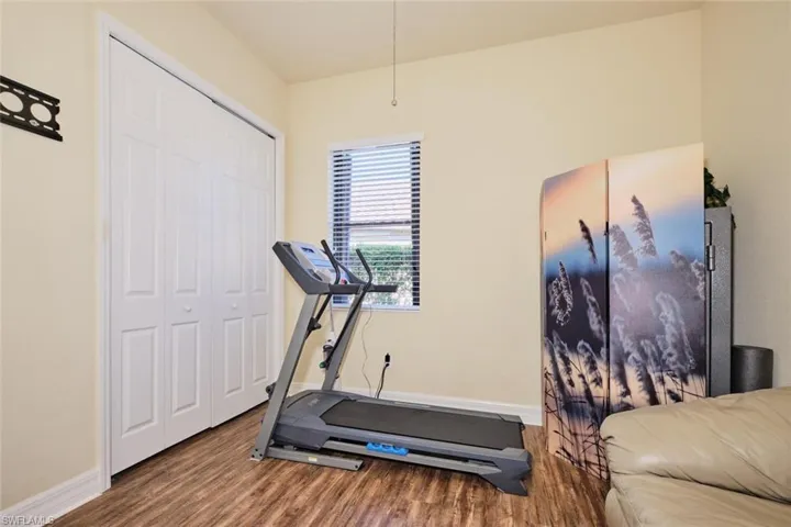 Workout area with hardwood / wood-style flooring