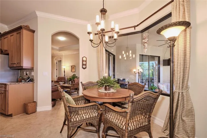 Dining area featuring a chandelier and ornamental molding
