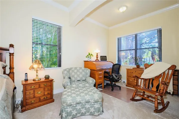 Carpeted office space with ornamental molding