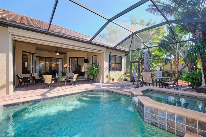 View of swimming pool with a patio area, ceiling fan, screen enclosure, and an in ground hot tub