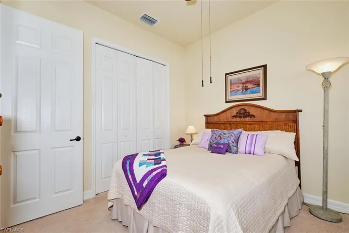 Carpeted bedroom featuring a closet