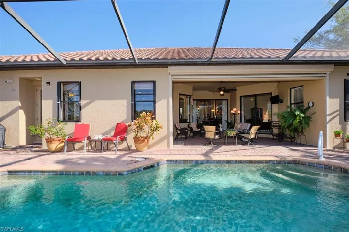 Rear view of house featuring a patio, screen enclosure