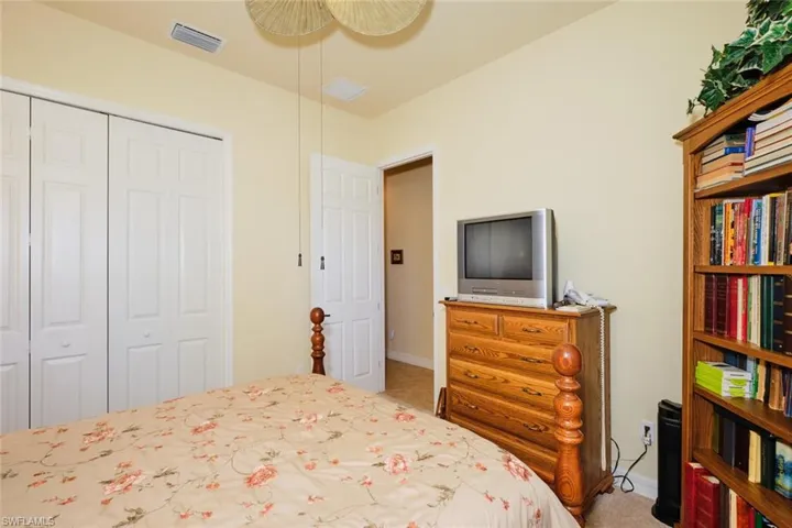 Bedroom featuring carpet floors, a closet, and ceiling fan