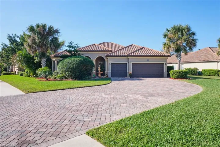 Mediterranean / spanish-style house with a front yard and a garage