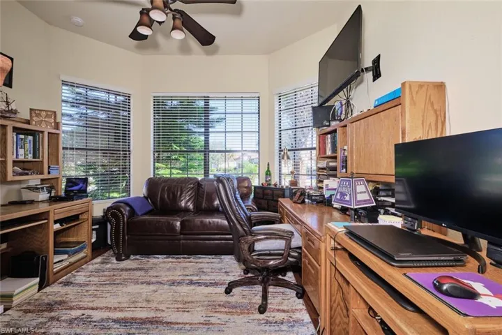 Home office with a wealth of natural light and ceiling fan