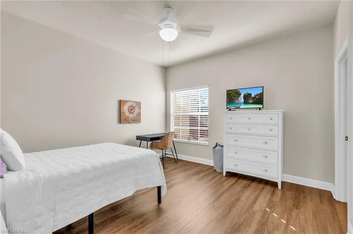 Bedroom featuring ceiling fan and light wood-type flooring