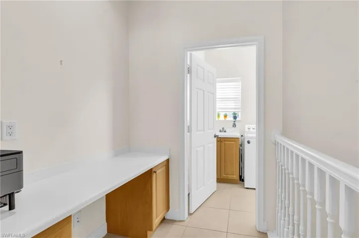 Hallway desk station featuring light tile patterned flooring