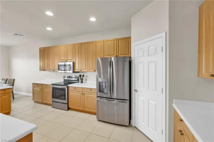 Kitchen featuring stainless steel appliances and light brown cabinets