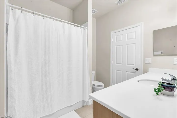 Bathroom featuring vanity and tub/shower combo