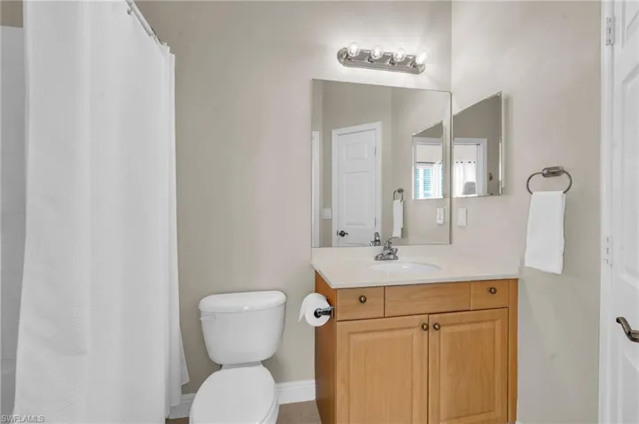 Bathroom with vanity and curtained shower